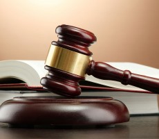 wooden gavel and books on wooden table,on brown background